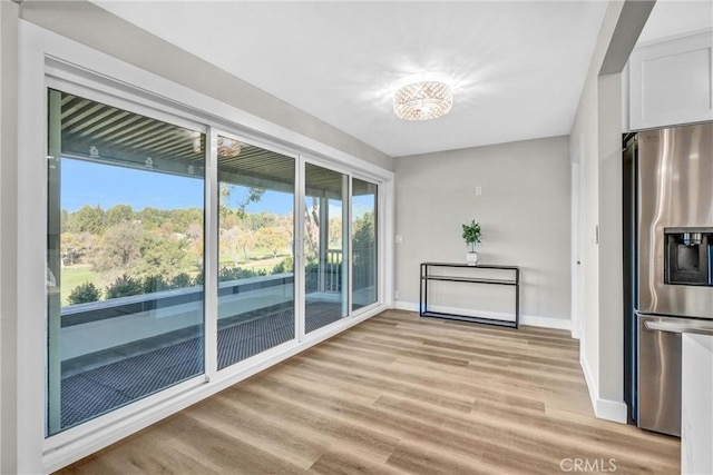 interior space with an inviting chandelier and light hardwood / wood-style floors