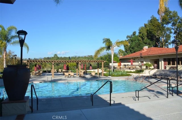 view of swimming pool with a pergola and a patio area