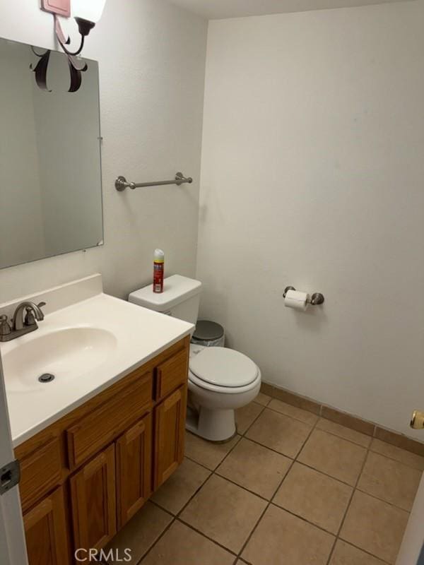 bathroom featuring tile patterned flooring, vanity, and toilet