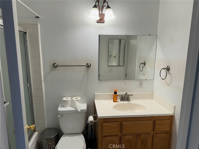 full bathroom with vanity, toilet, and bath / shower combo with glass door