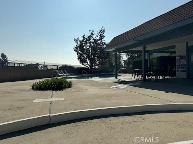 view of yard with a fenced in pool and a patio