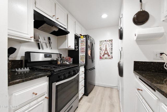 kitchen featuring light hardwood / wood-style floors, dark stone countertops, white cabinetry, and gas range