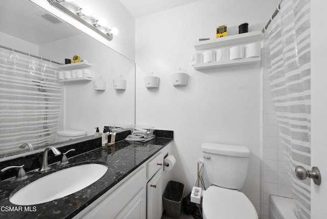 bathroom featuring vanity and toilet