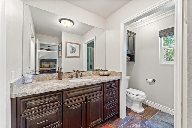 bathroom with vanity, ceiling fan, and toilet