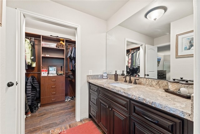 bathroom with hardwood / wood-style floors and vanity