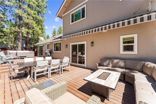 wooden terrace featuring an outdoor living space with a fire pit