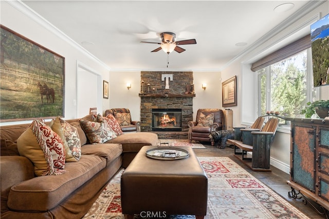 living room featuring a stone fireplace, ceiling fan, wood-type flooring, and ornamental molding