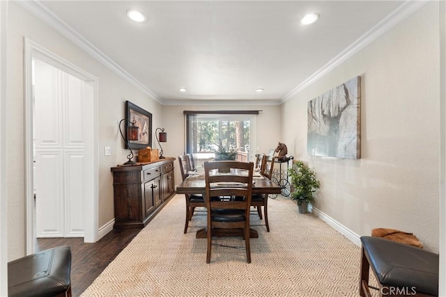 dining area with wood-type flooring and ornamental molding