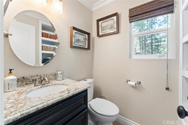 bathroom with crown molding, vanity, and toilet