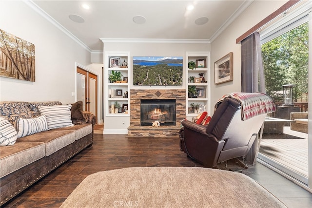 living room featuring a fireplace, crown molding, dark hardwood / wood-style flooring, and built in shelves