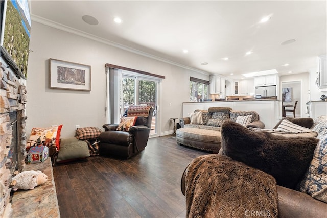 living room featuring a fireplace, crown molding, and dark hardwood / wood-style flooring