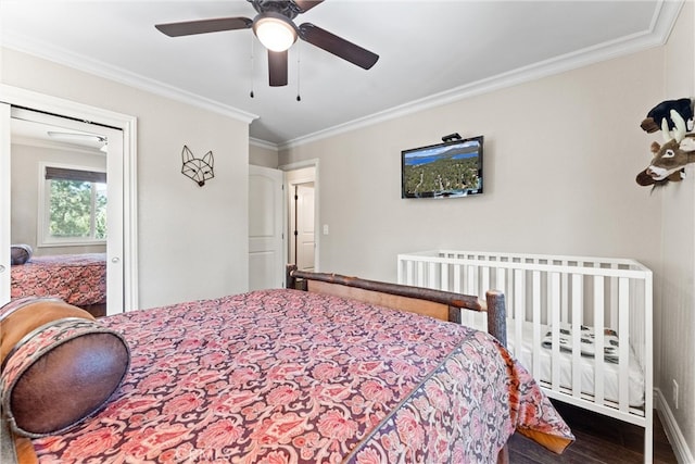 bedroom featuring dark hardwood / wood-style floors, ceiling fan, and ornamental molding