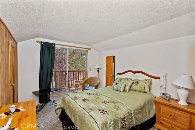 carpeted bedroom featuring access to exterior, a textured ceiling, and vaulted ceiling