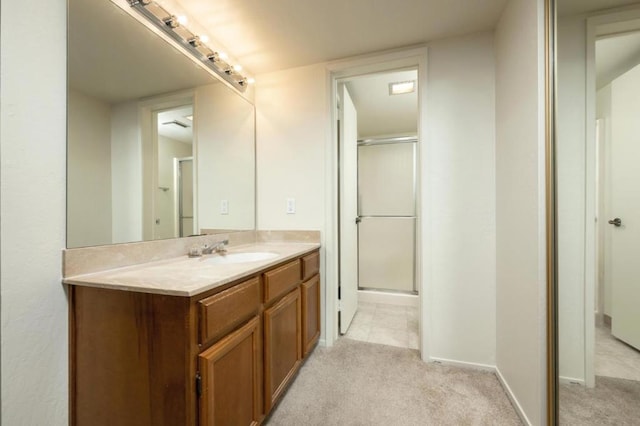 bathroom with vanity and a shower with door