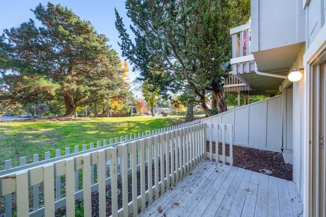 wooden deck featuring a lawn