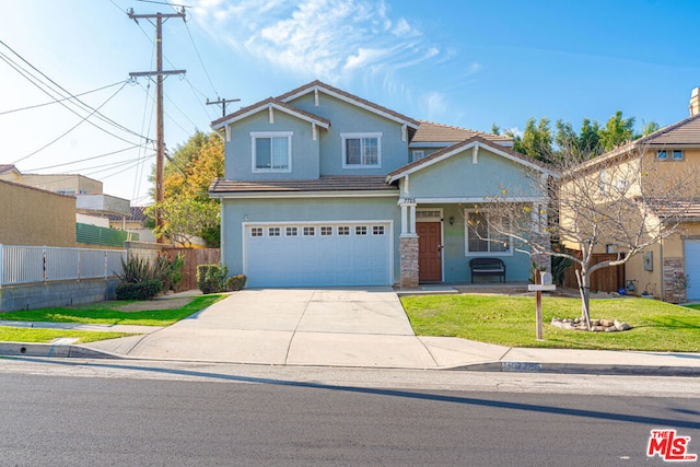 view of front of house with a front yard and a garage