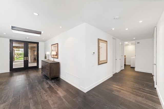 hall featuring dark wood finished floors, visible vents, french doors, and baseboards