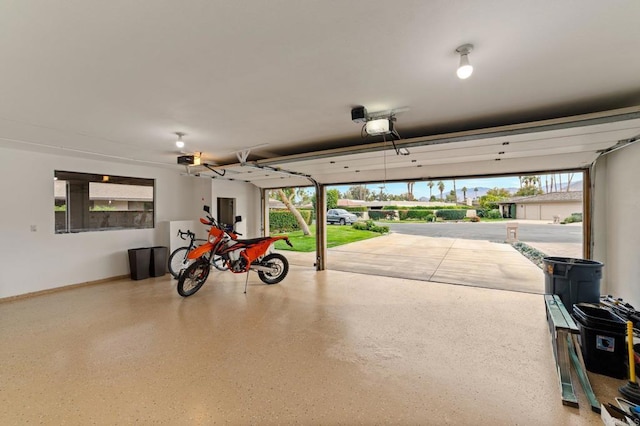 garage featuring baseboards and a garage door opener