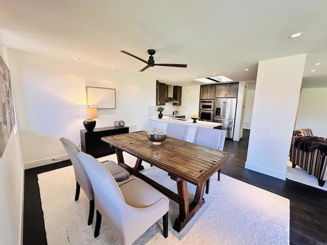 dining room with dark wood finished floors, recessed lighting, a ceiling fan, and baseboards