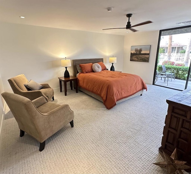 bedroom with baseboards, light carpet, ceiling fan, expansive windows, and access to outside