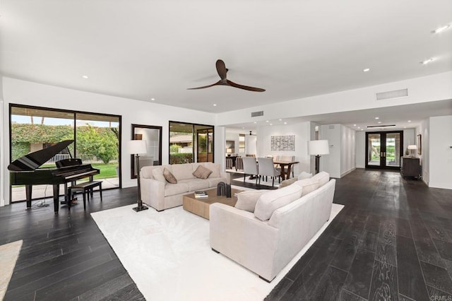 living area with recessed lighting, wood finished floors, visible vents, and french doors