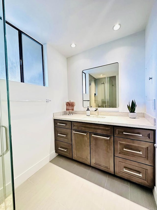 bathroom with tile patterned flooring, recessed lighting, a stall shower, and vanity