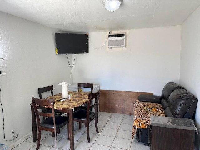 dining room with a wall mounted air conditioner and light tile patterned floors