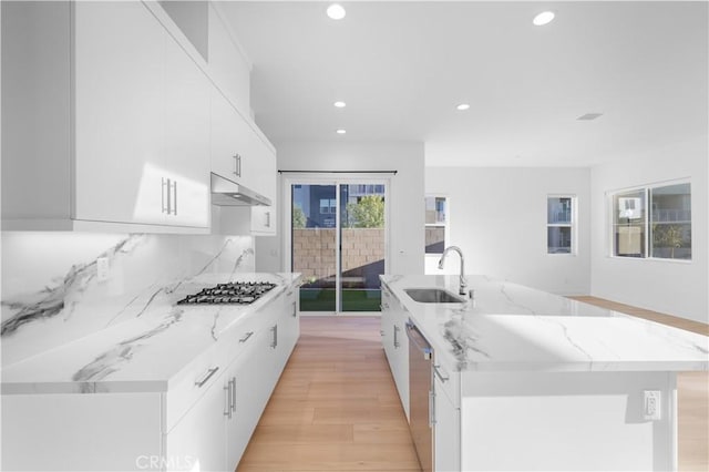 kitchen featuring sink, white cabinetry, a kitchen island with sink, and stainless steel appliances