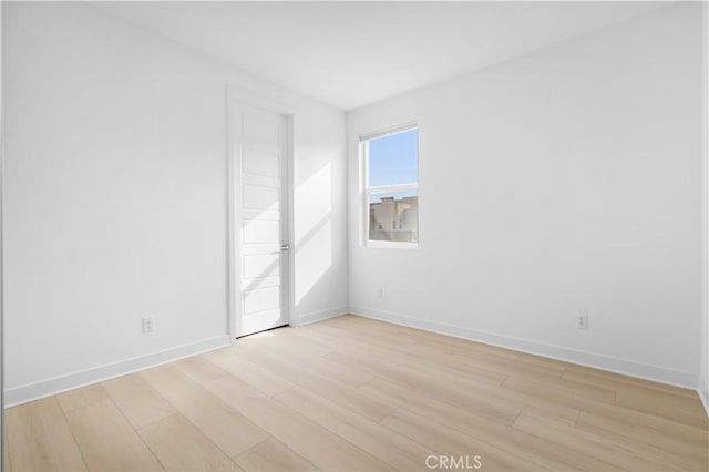 empty room with light hardwood / wood-style floors