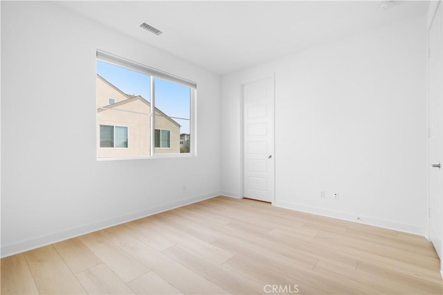 spare room featuring light hardwood / wood-style floors