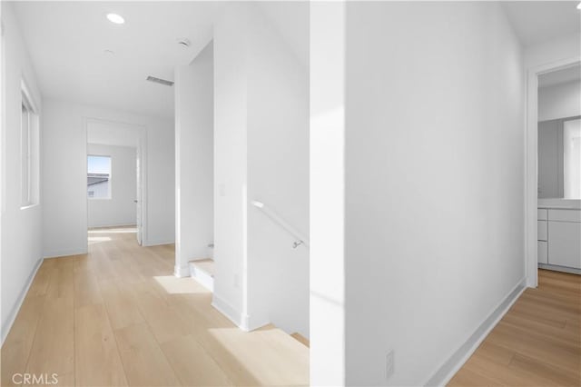 hallway with light hardwood / wood-style flooring