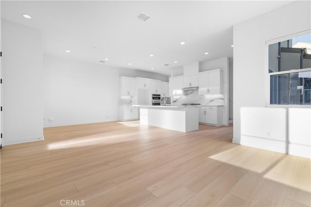 unfurnished living room featuring light hardwood / wood-style floors