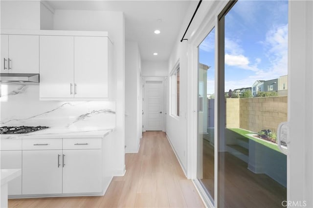 corridor with light hardwood / wood-style flooring