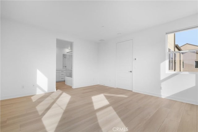 spare room featuring light hardwood / wood-style flooring