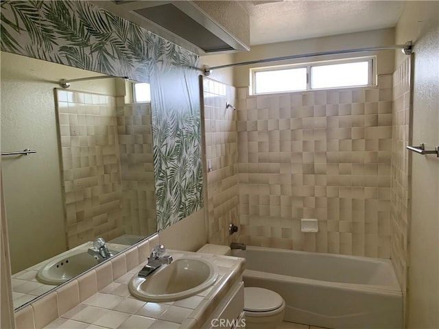 full bathroom with vanity, toilet, and tiled shower / bath