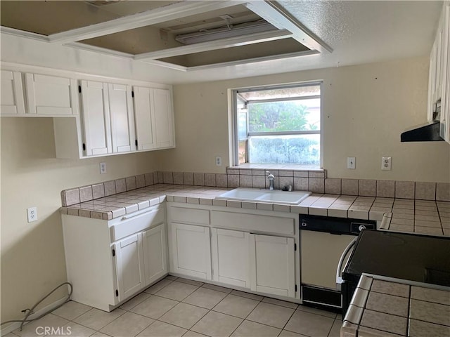 kitchen featuring white cabinetry, sink, light tile patterned floors, and tile countertops