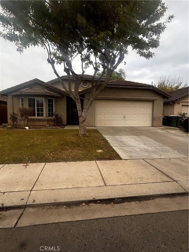 single story home featuring a garage and a front lawn