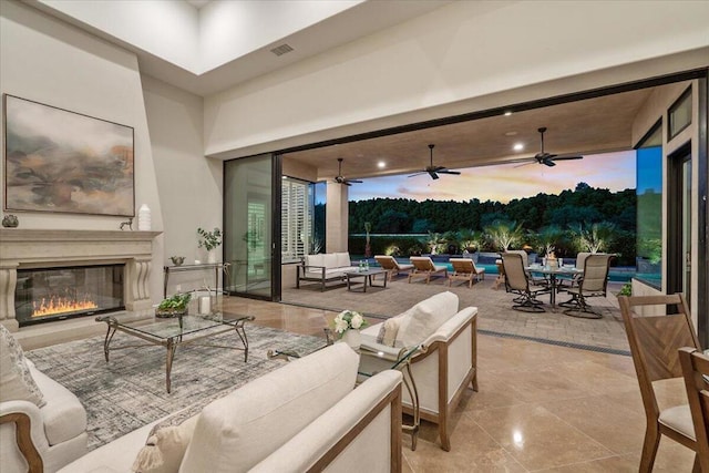 patio terrace at dusk with an outdoor living space with a fireplace