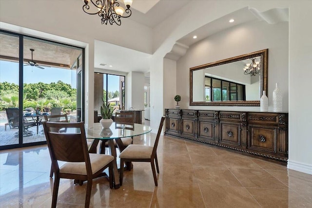 dining area featuring ceiling fan with notable chandelier