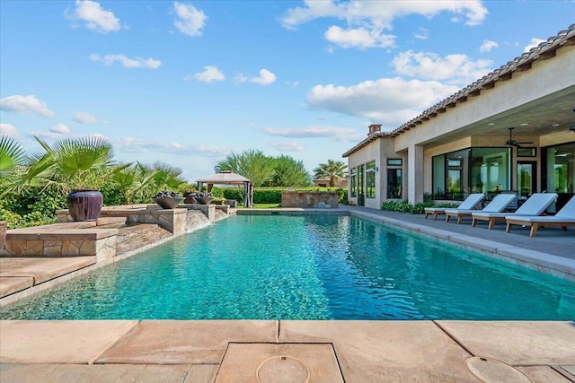 view of pool featuring ceiling fan, a patio area, and pool water feature