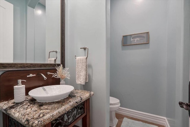 bathroom featuring toilet and vanity