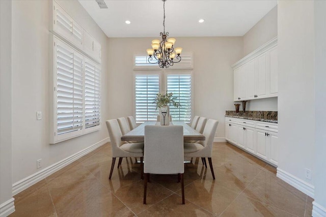 dining area with light tile patterned flooring and a chandelier