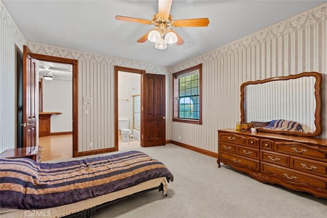 bedroom featuring ensuite bathroom, ceiling fan, and light carpet