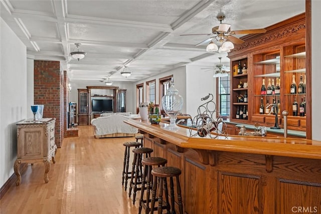 bar with beam ceiling, light wood-type flooring, and coffered ceiling