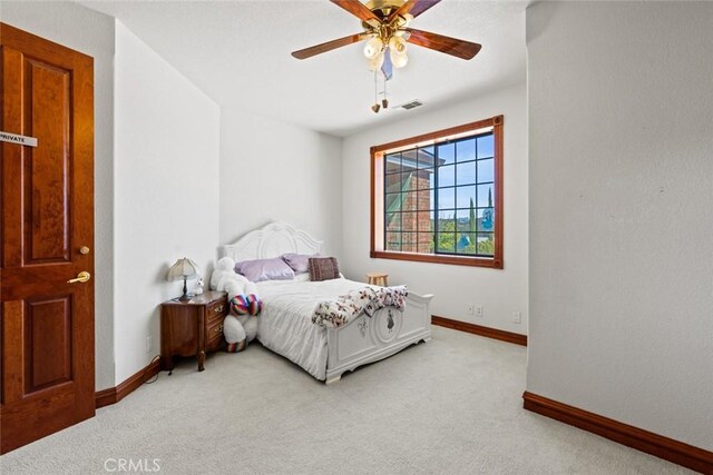 bedroom featuring ceiling fan and light colored carpet