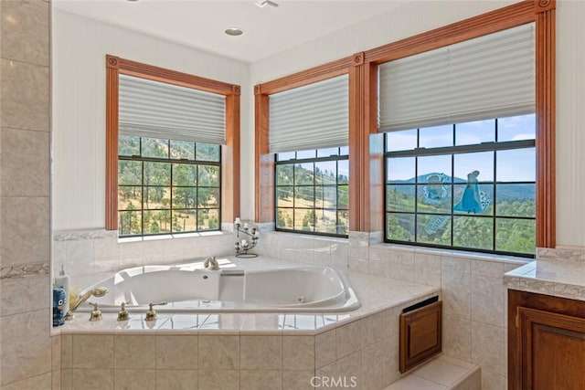 bathroom with a relaxing tiled tub and vanity