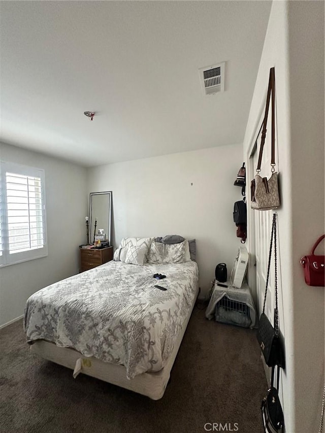 bedroom featuring dark carpet