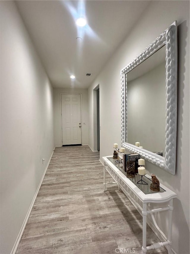 hallway with light hardwood / wood-style flooring