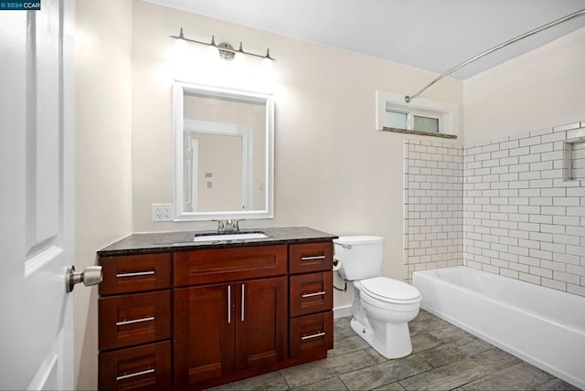 full bathroom with toilet, vanity, and tiled shower / bath combo