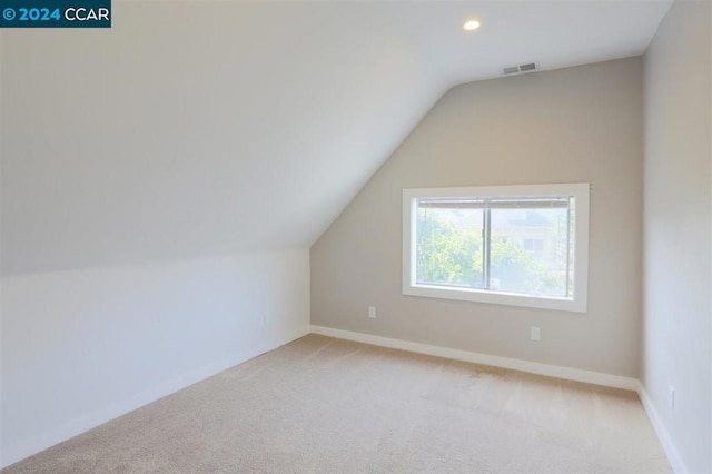 bonus room with carpet and vaulted ceiling